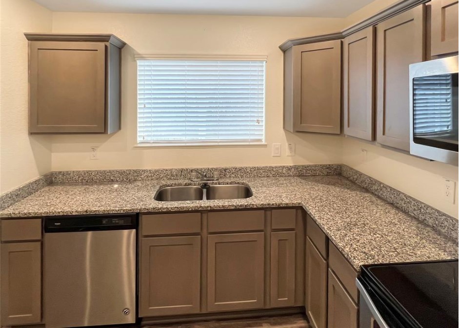 21155 Gosling Road, Unit 47B Spring, TX 77388 - Photo 7 of 29 a kitchen with granite countertop cabinets sink and window
