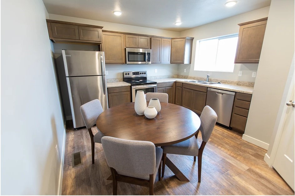21155 Gosling Road, Unit 47B Spring, TX 77388 - Photo 8 of 29 a kitchen with a table chairs refrigerator and microwave