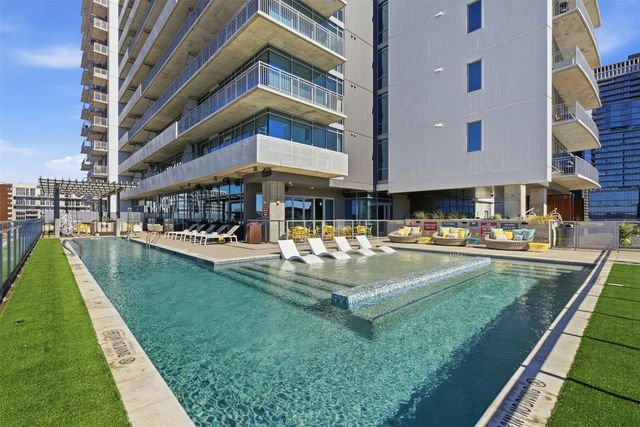 a swimming pool view with a outdoor seating