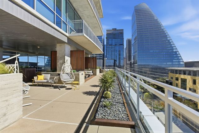 a view of a balcony with chairs and wooden floor