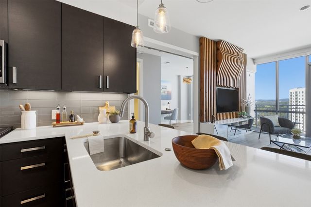 a kitchen with a sink and a refrigerator