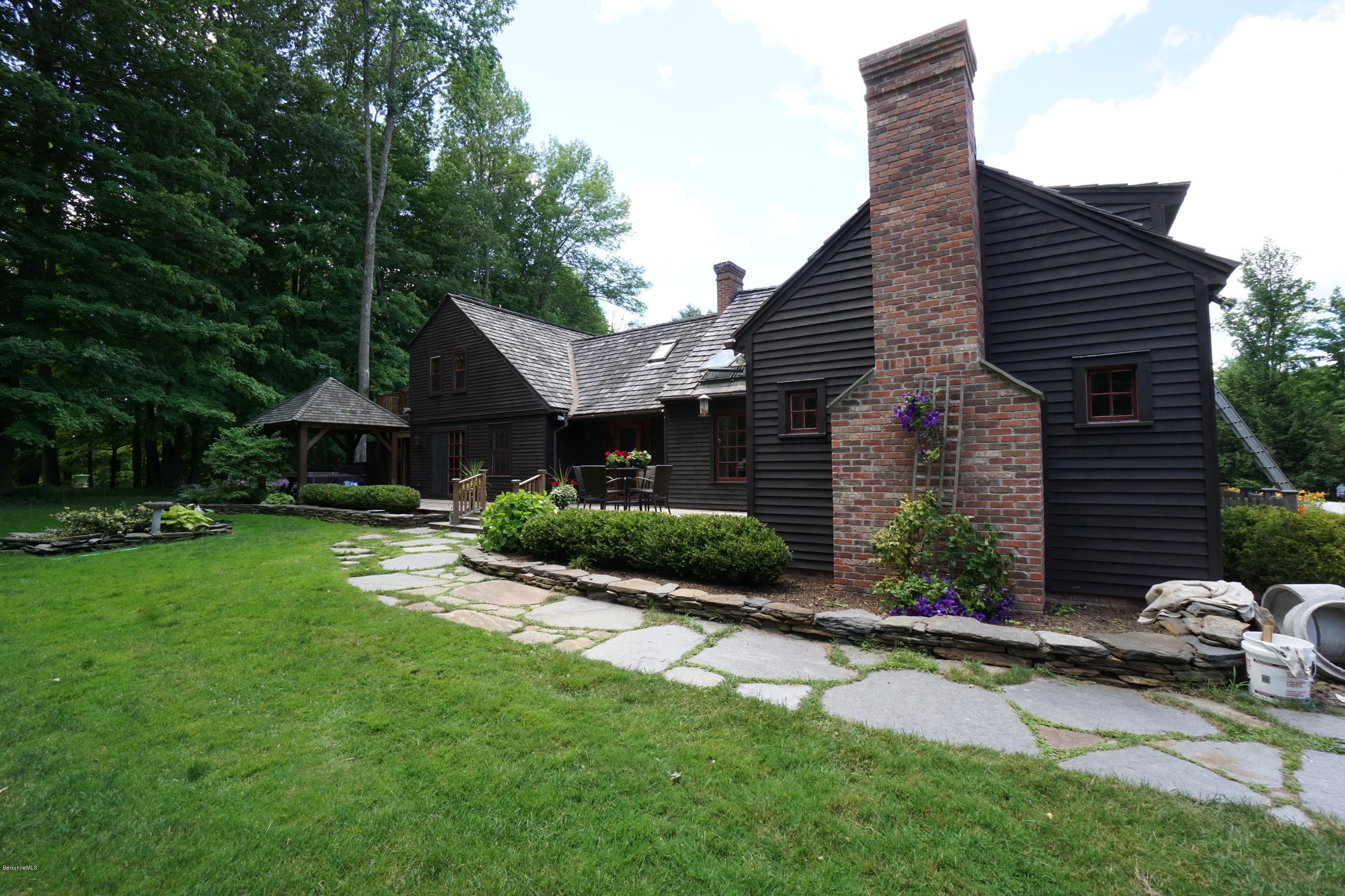 408 Summit Road Richmond, MA 01254 - Photo 2 of 36 a front view of a house with a yard and green space