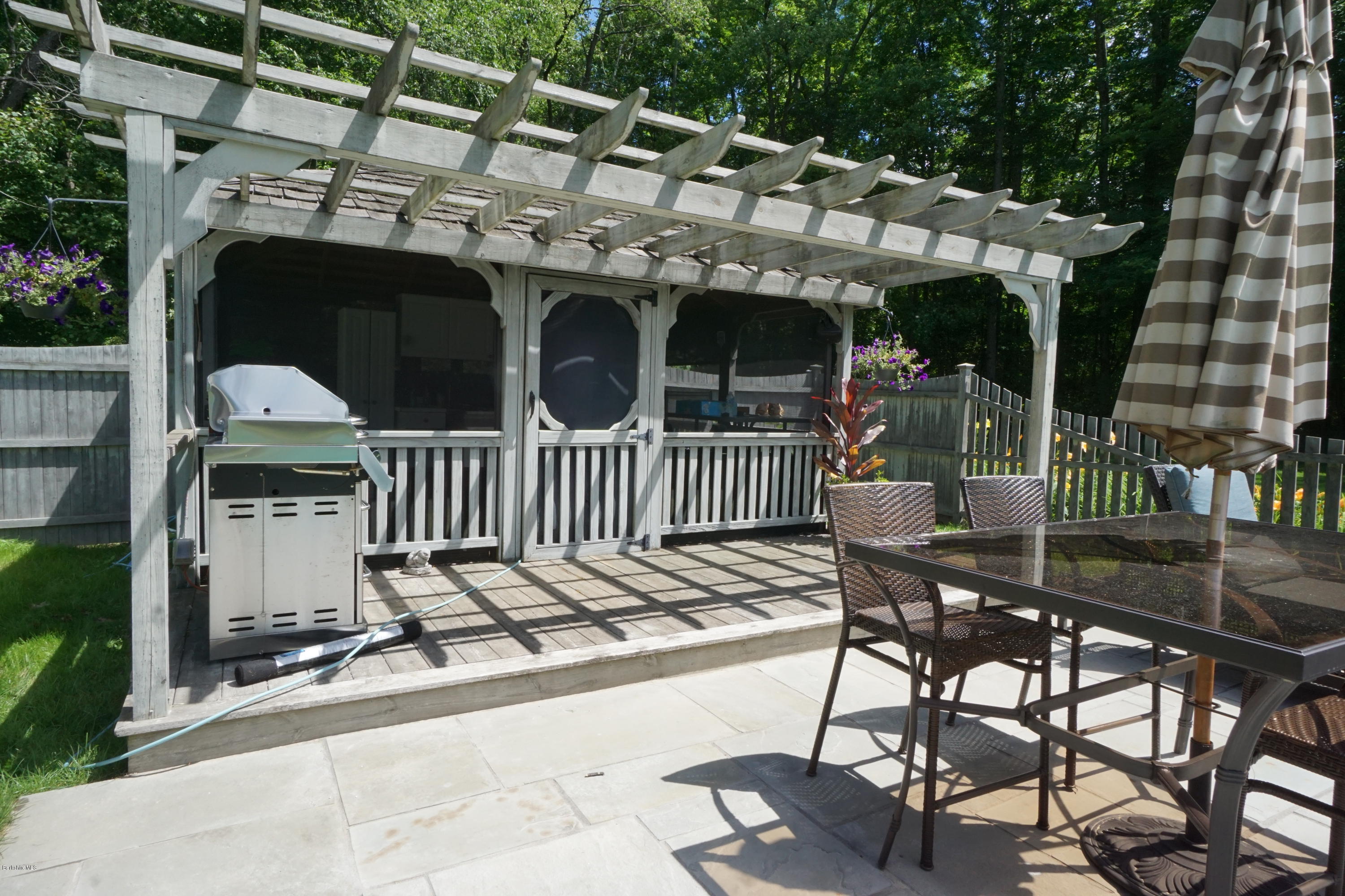 408 Summit Road Richmond, MA 01254 - Photo 5 of 36 a view of a patio with table and chairs with wooden floor and fence