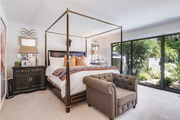 a bedroom with a bed lamp and window
