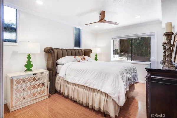 a bedroom with a bed and a dresser with mirror