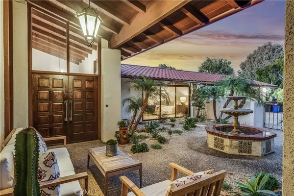 a view of a patio with table and chairs potted plants