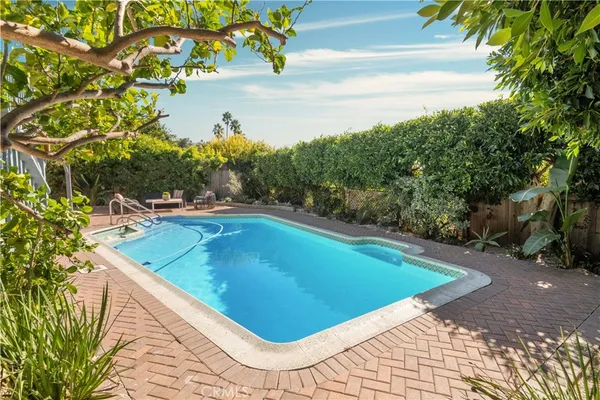 a view of a swimming pool with an outdoor space and seating area