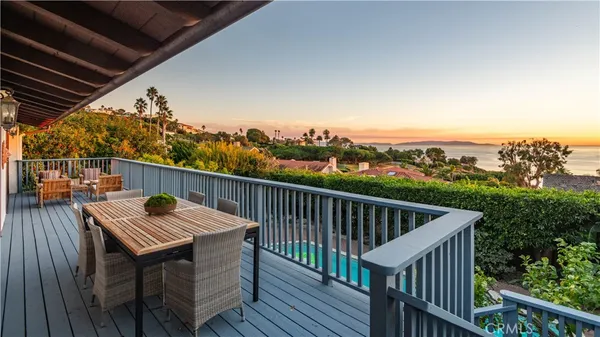 a balcony with wooden floor and city view