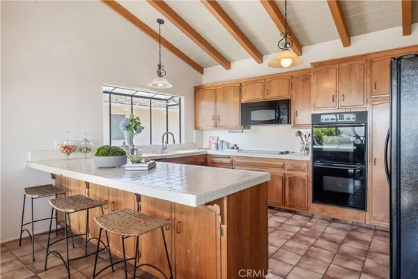 a kitchen with stainless steel appliances a sink stove and refrigerator