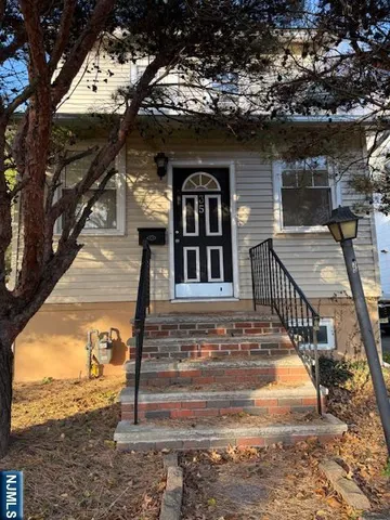 a view of a house with a large tree