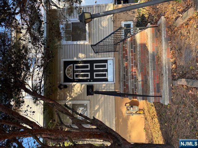 a view of a house with a large tree