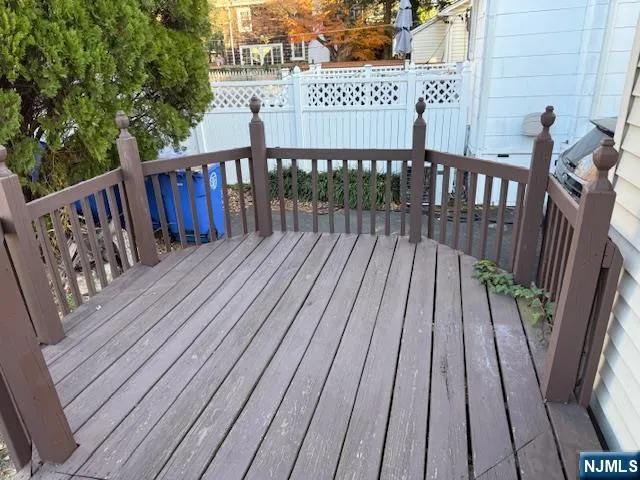 a view of deck with wooden floor and fence