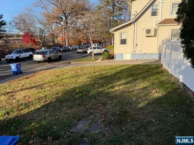 a view of a yard with cars