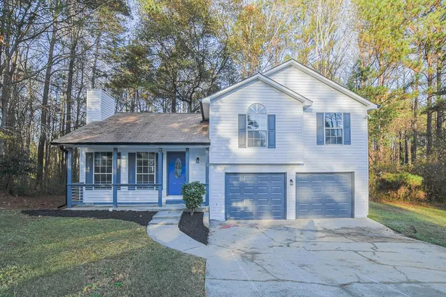 a front view of a house with garden