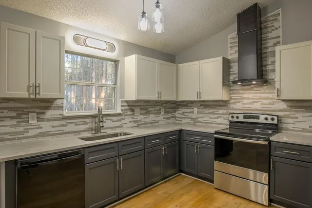 a kitchen with a sink stove and cabinets