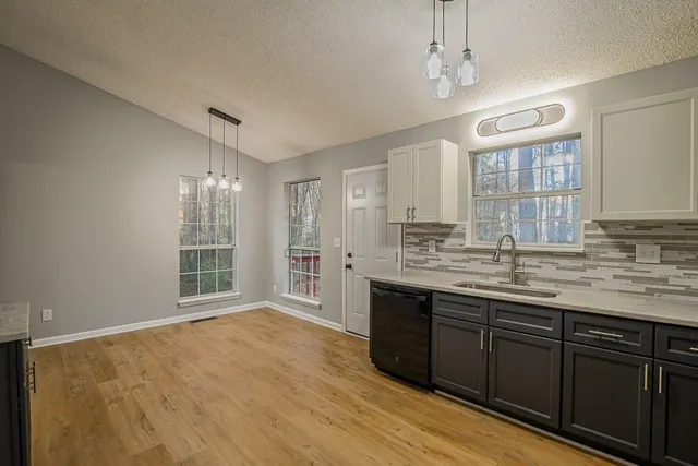 a bathroom with a granite countertop sink a large mirror and shower