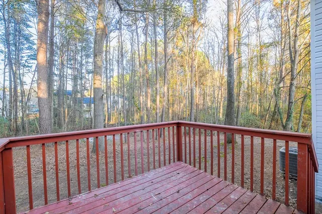 a view of wooden balcony with trees