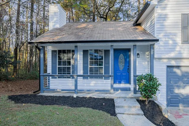 a front view of a house with garden