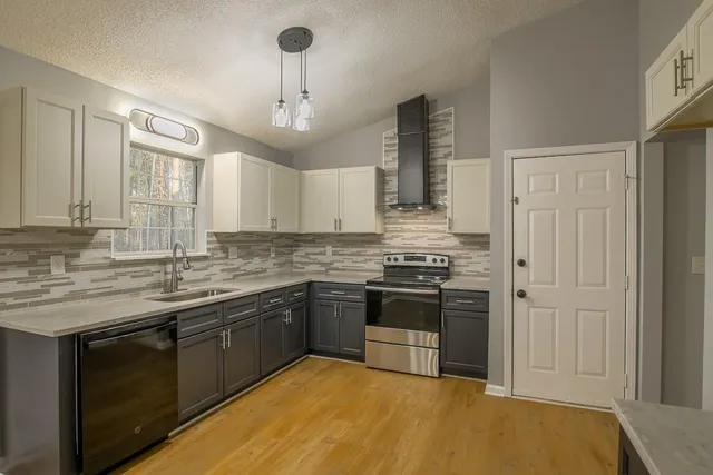 a kitchen with stainless steel appliances granite countertop a stove and a sink