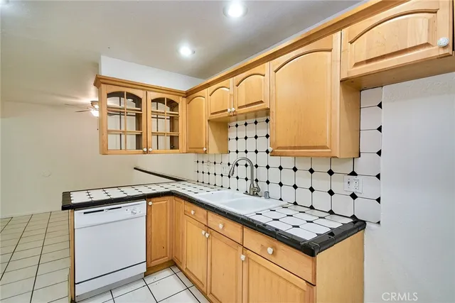 a kitchen with granite countertop a sink stove and cabinets