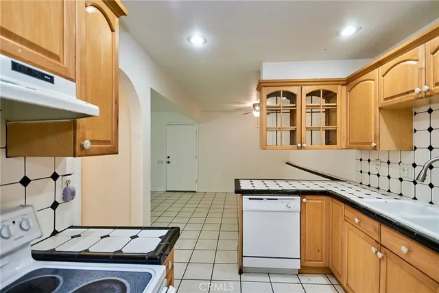 a kitchen with granite countertop a sink and a stove top oven