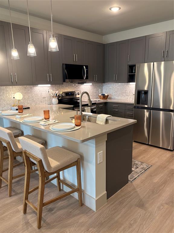 3751 Heritage Towne Blvd. Boulevard Midlothian, TX 76065 - Photo 2 of 20 a kitchen with a sink a microwave a stove and refrigerator