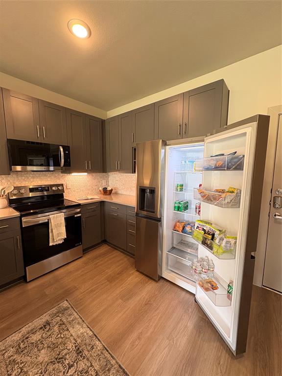 3751 Heritage Towne Blvd. Boulevard Midlothian, TX 76065 - Photo 3 of 20 a kitchen with stainless steel appliances a refrigerator and a stove top oven