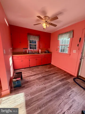 a room with wooden floors and furniture