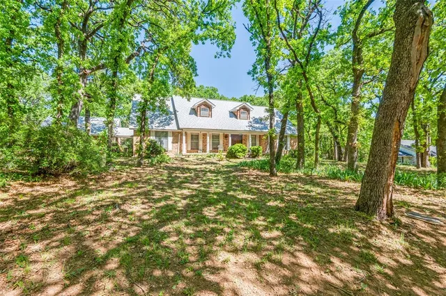 a view of a house with a tree in a yard