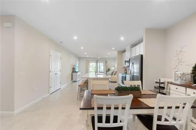 a large kitchen with a table and chairs