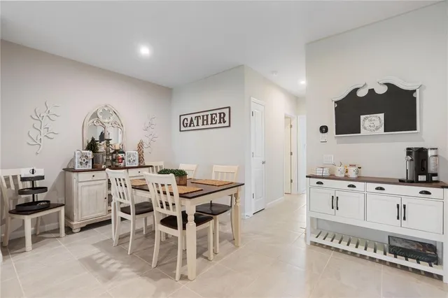 a kitchen with granite countertop a table and chairs in it