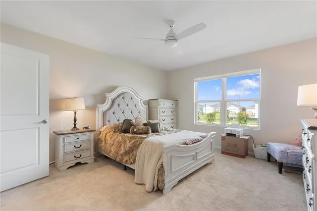 a spacious bedroom with a bed and a chandelier