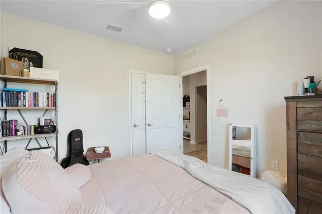 a bedroom with a bed and a book shelf