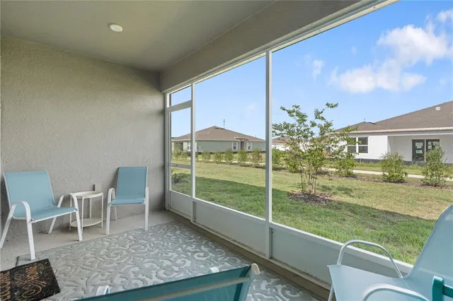 a view of a chair and tables in the balcony