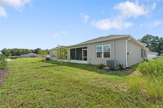a view of a house with backyard sitting area and garden