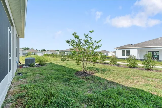 a view of a house with yard and a garden