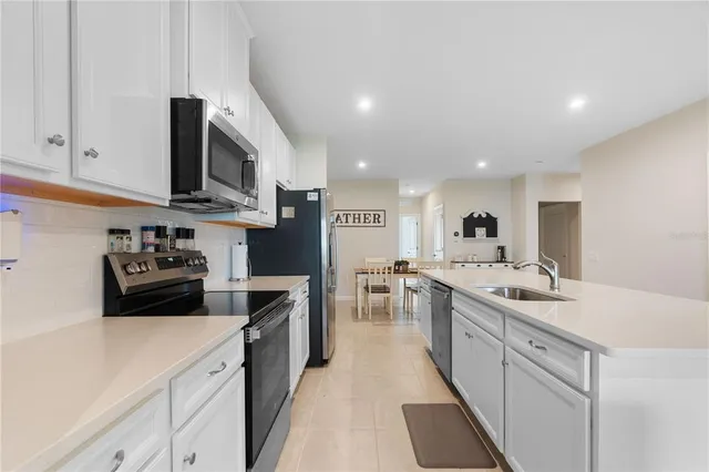 a kitchen with stainless steel appliances granite countertop a sink and cabinets