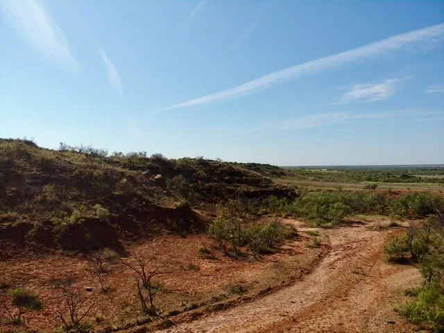 a view of a large mountain with mountains in the background