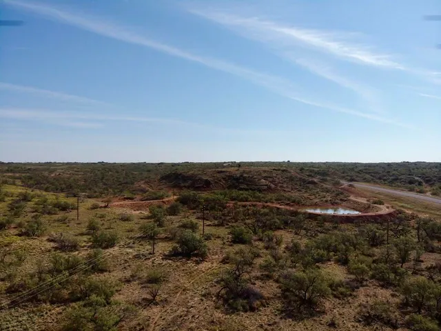 a view of a large body of water with lots of trees in all around