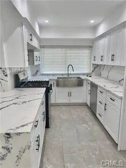 a kitchen with a sink stove and cabinets