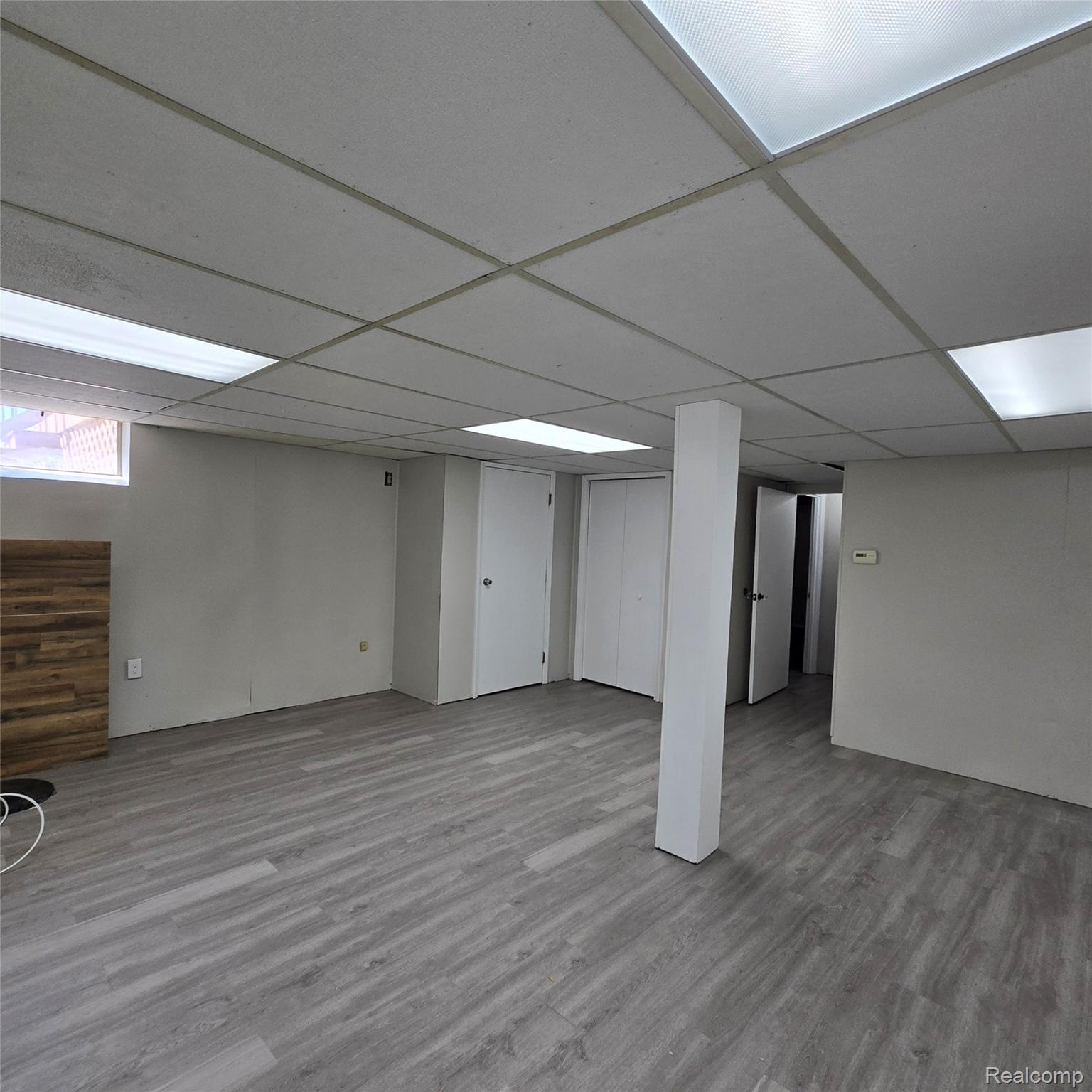 311 Nevada Avenue Rochester, MI 48309 - Photo 62 of 70 Finished lower level featuring wood-finish flooring, drop ceiling with integrated lighting, and a window for natural light