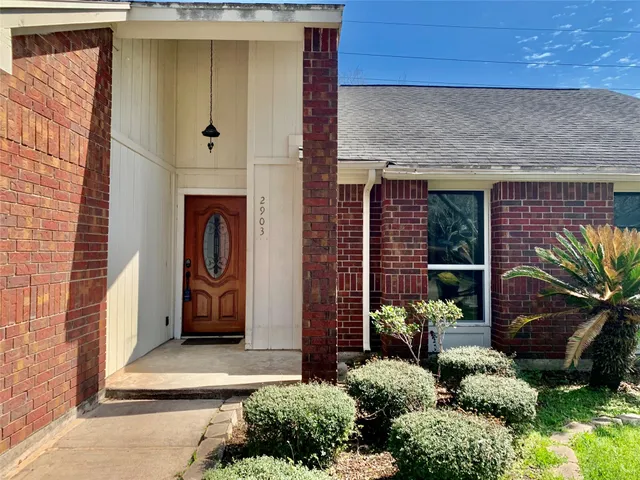a couple of potted plants in front of door