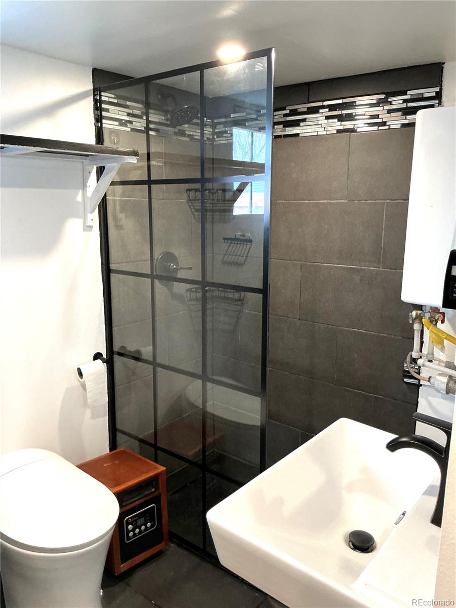 Undisclosed Address Aurora, CO 80010 - Photo 11 of 23 a bathroom with a sink toilet and shower