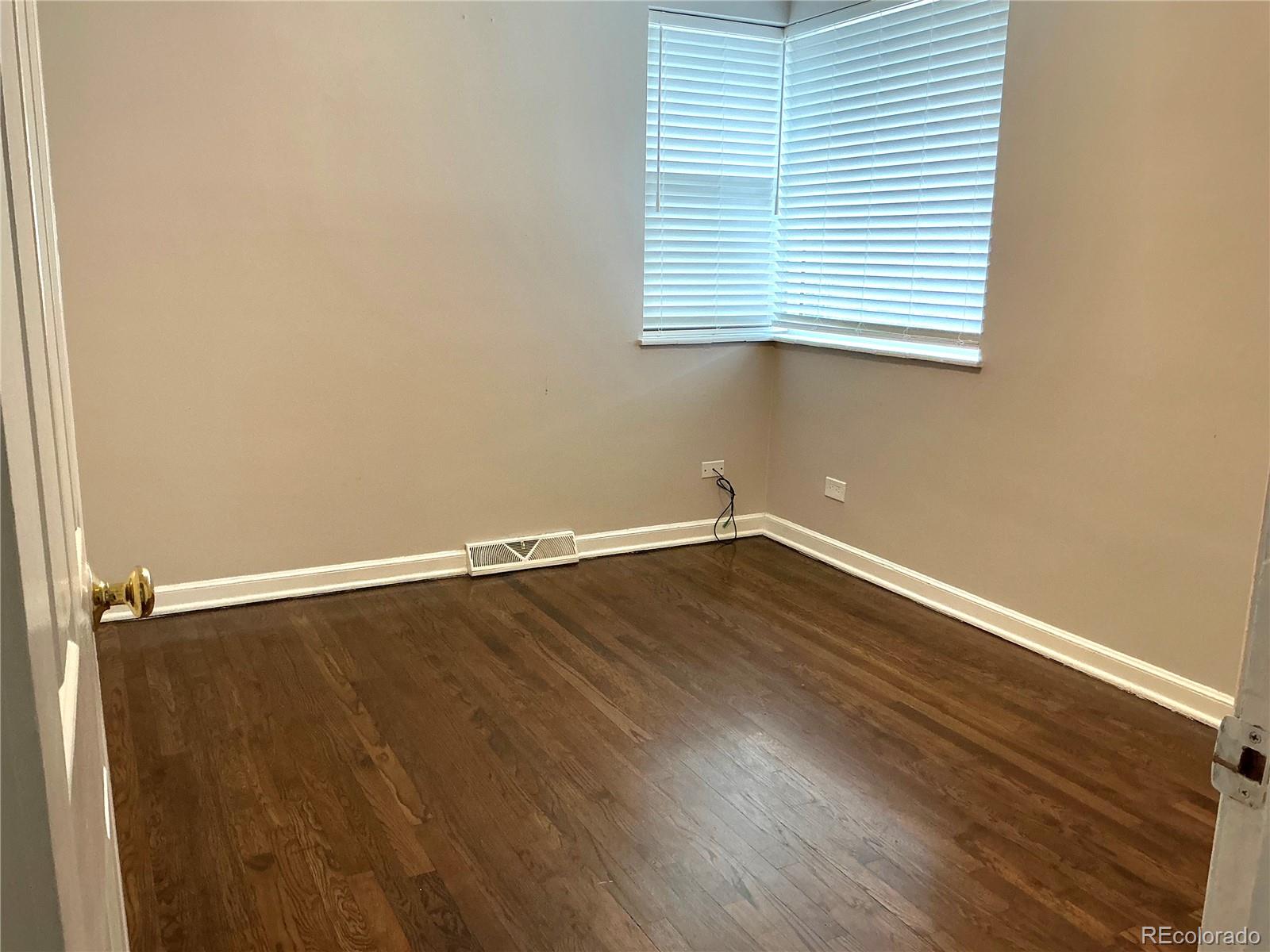 Undisclosed Address Aurora, CO 80010 - Photo 15 of 23 an empty room with wooden floor and windows