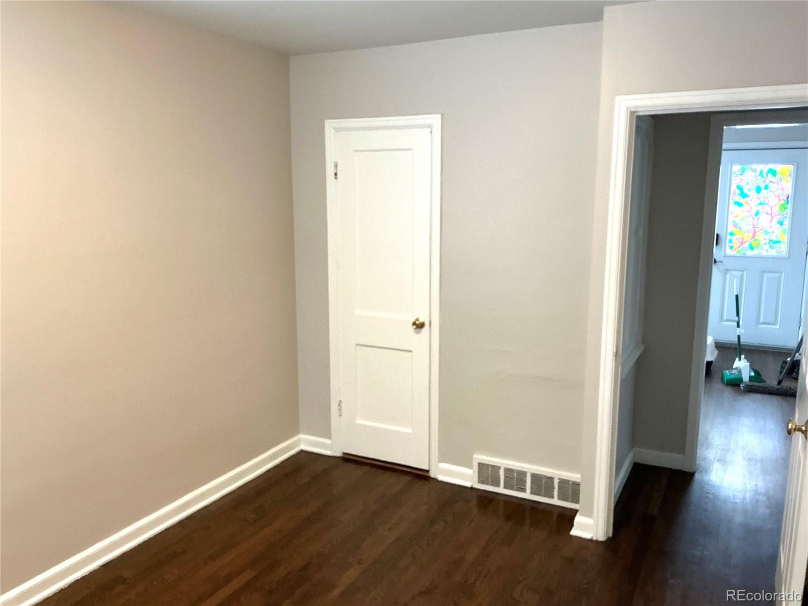 Undisclosed Address Aurora, CO 80010 - Photo 16 of 23 an empty room with wooden floor and a window