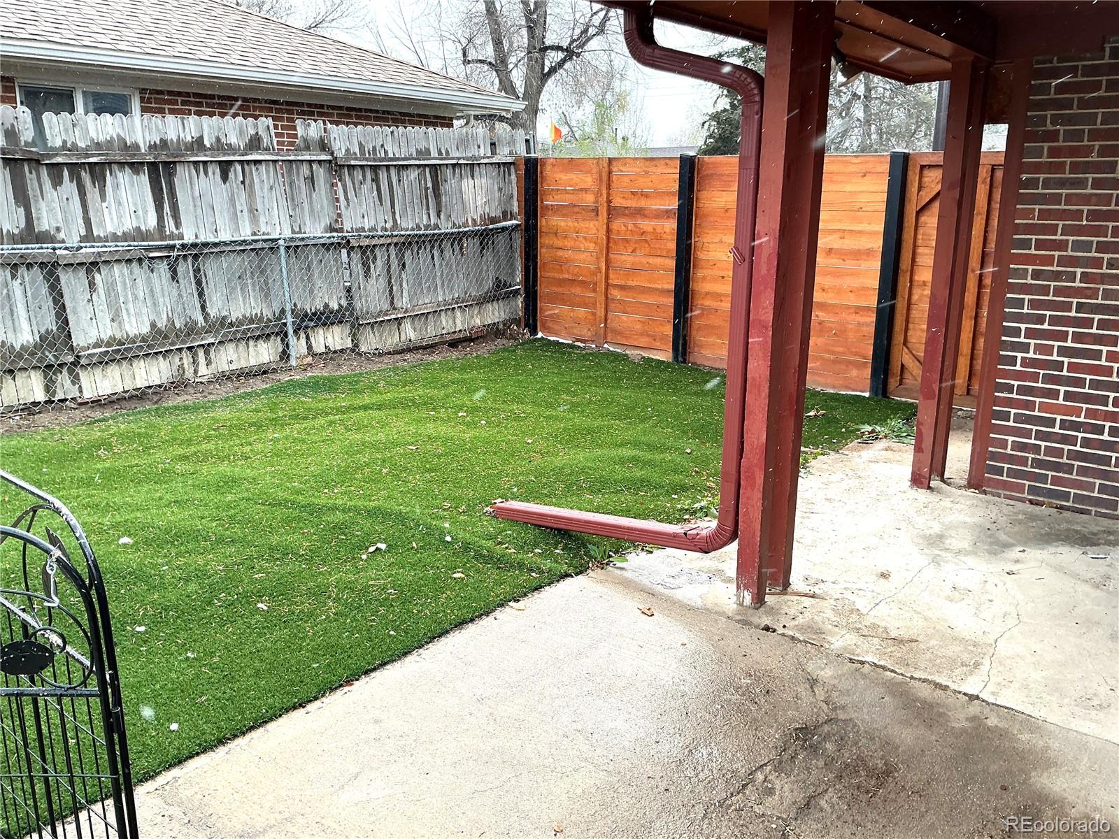 Undisclosed Address Aurora, CO 80010 - Photo 20 of 23 a view of a backyard with a large tree
