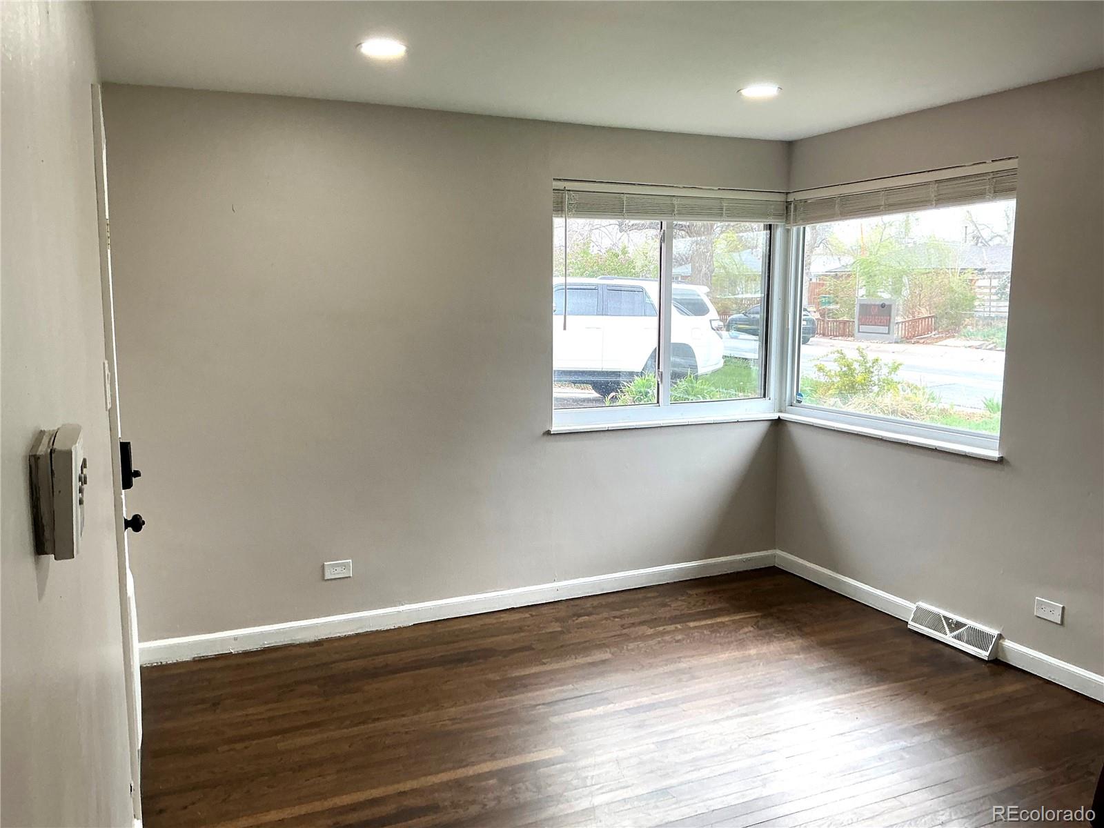 Undisclosed Address Aurora, CO 80010 - Photo 2 of 23 wooden floor in an empty room with a window
