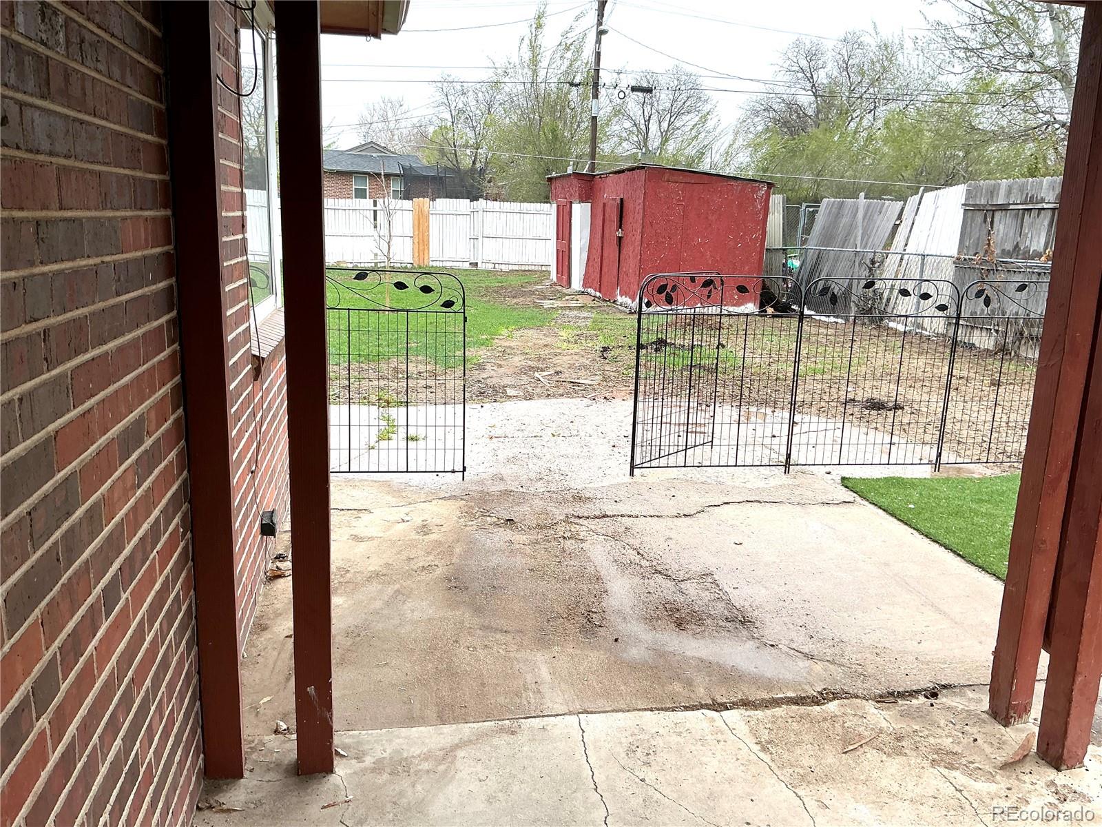 Undisclosed Address Aurora, CO 80010 - Photo 21 of 23 a view of a house with a floor to ceiling window and wooden fence