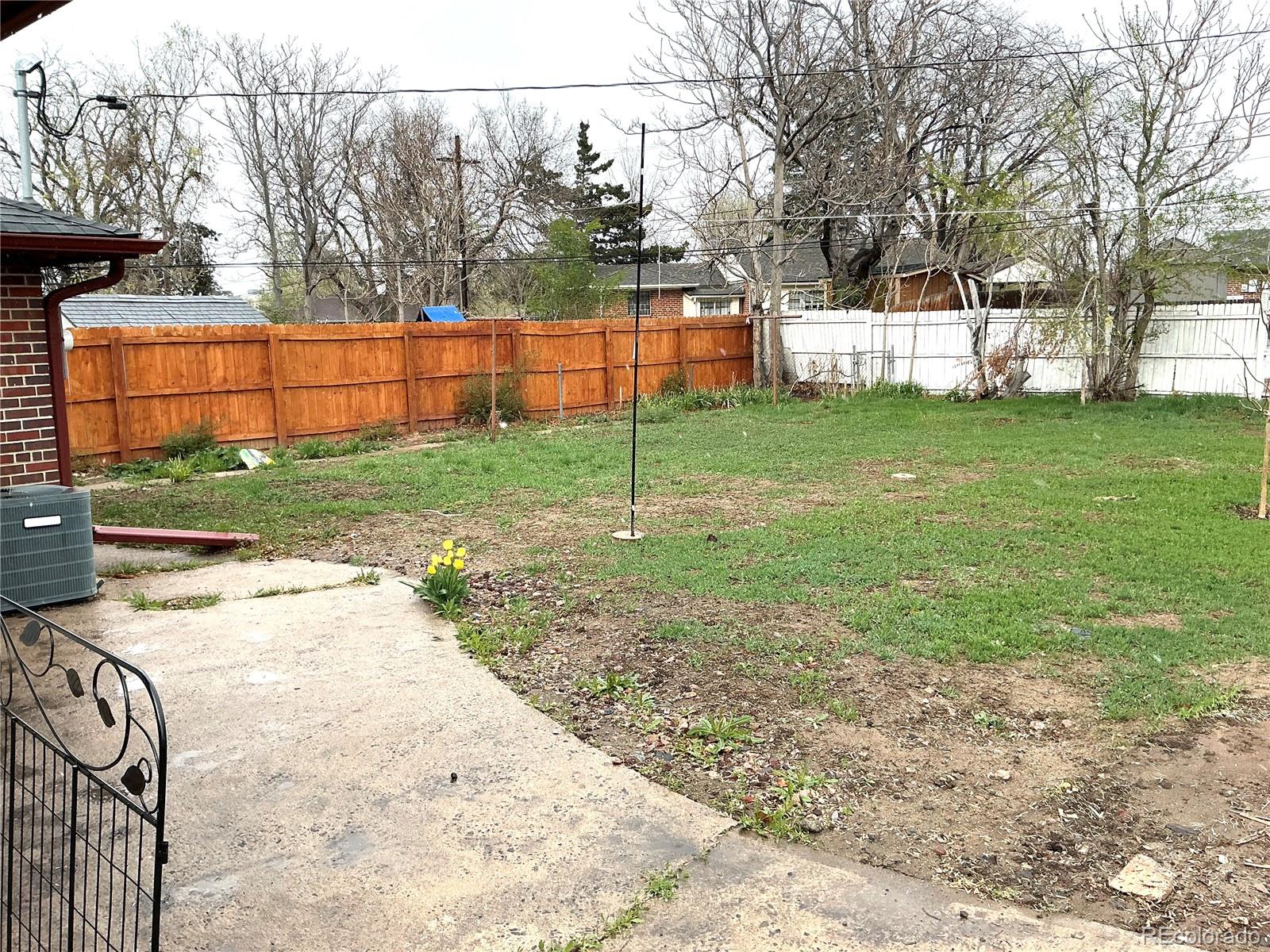 Undisclosed Address Aurora, CO 80010 - Photo 22 of 23 a view of a backyard with a garden and plants