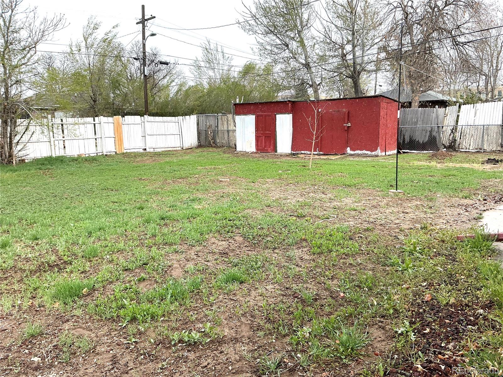Undisclosed Address Aurora, CO 80010 - Photo 23 of 23 a view of a backyard with a small cabin